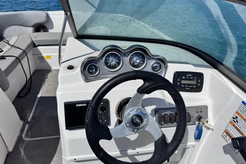 Slide: The Image of Close-up of a 2022 NauticStar 223DC Sport Deck boat propeller on gravel. - 9