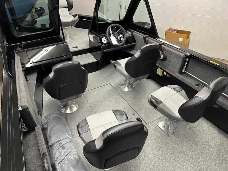 Slide: The Image of 2025 Crestliner 1850 Commander boat interior with four seats and steering console. - 6