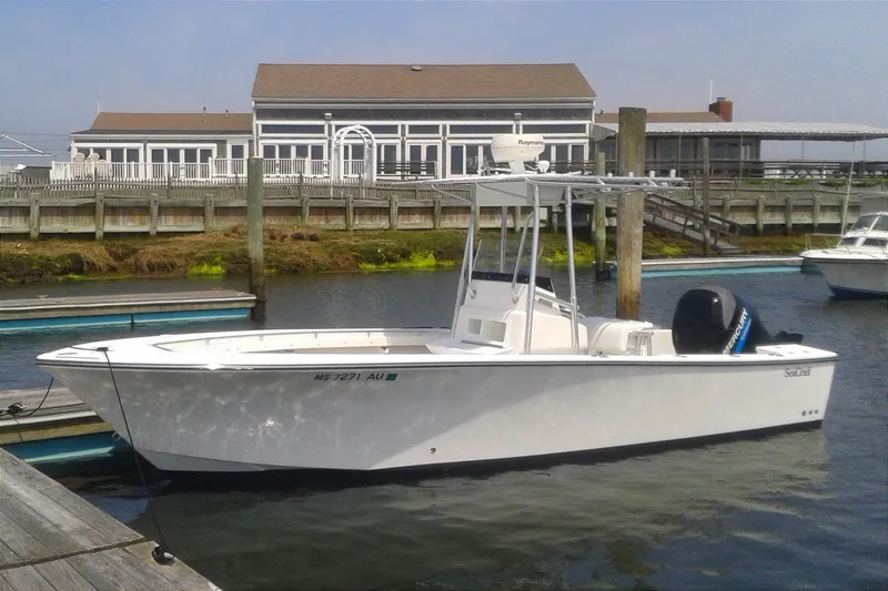 The Image of 2003 SeaCraft SC 23 Classic boat docked at marina with waterfront building in background. - 0