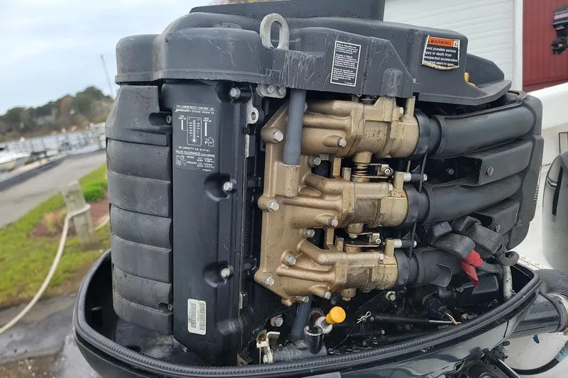 Slide: The Image of Close-up of a 2003 SeaCraft SC 23 Classic boat engine, showcasing intricate mechanical details. - 14