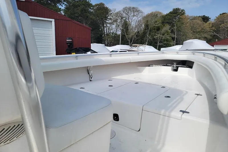Slide: The Image of 2003 SeaCraft SC 23 Classic boat interior with storage compartments, docked near red building. - 15