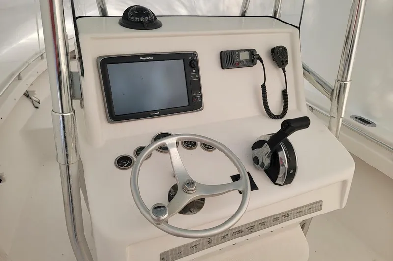 Slide: The Image of 2003 SeaCraft SC 23 Classic boat dashboard with steering wheel and navigation equipment. - 7