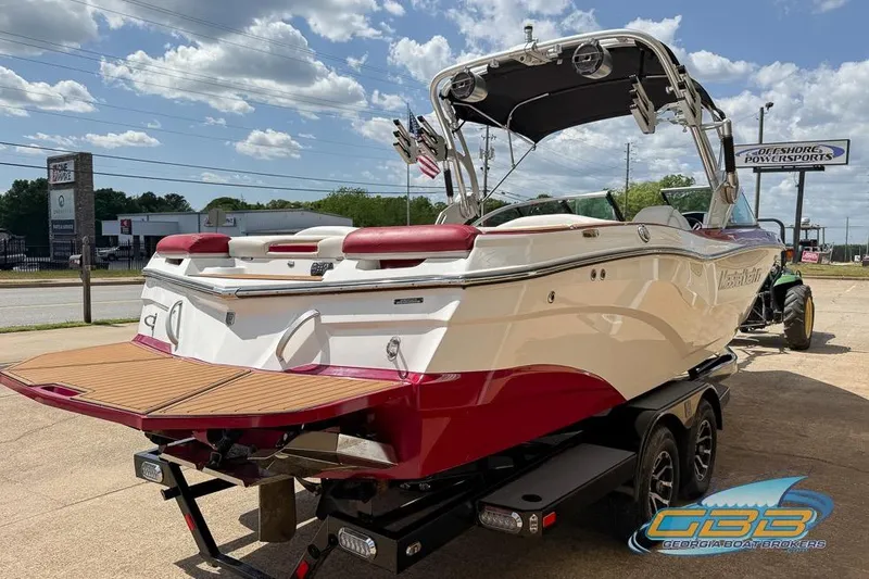 Slide: The Image of 2018 MasterCraft XT25 boat on trailer, featuring sleek design and vibrant red accents. - 16