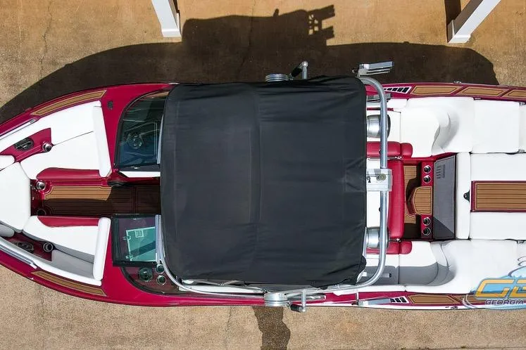 Slide: The Image of Overhead view of a 2018 MasterCraft XT25 boat with a black cover. - 21