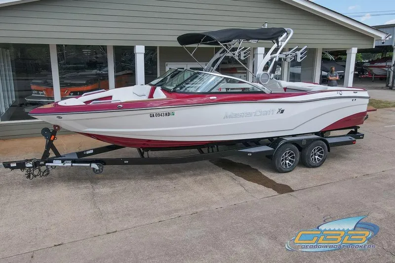 Slide: The Image of 2018 MasterCraft XT25 boat on trailer outside dealership. - 25