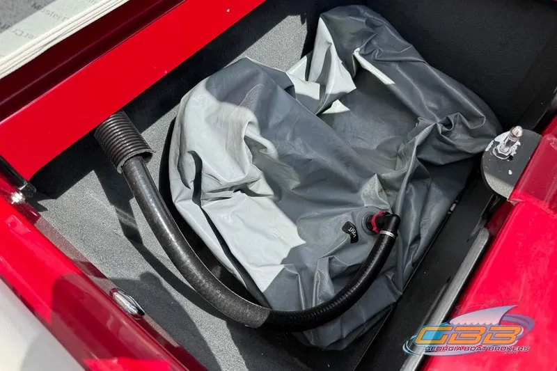 Slide: The Image of Storage compartment of a 2018 MasterCraft XT25 boat with hose and cover. - 30