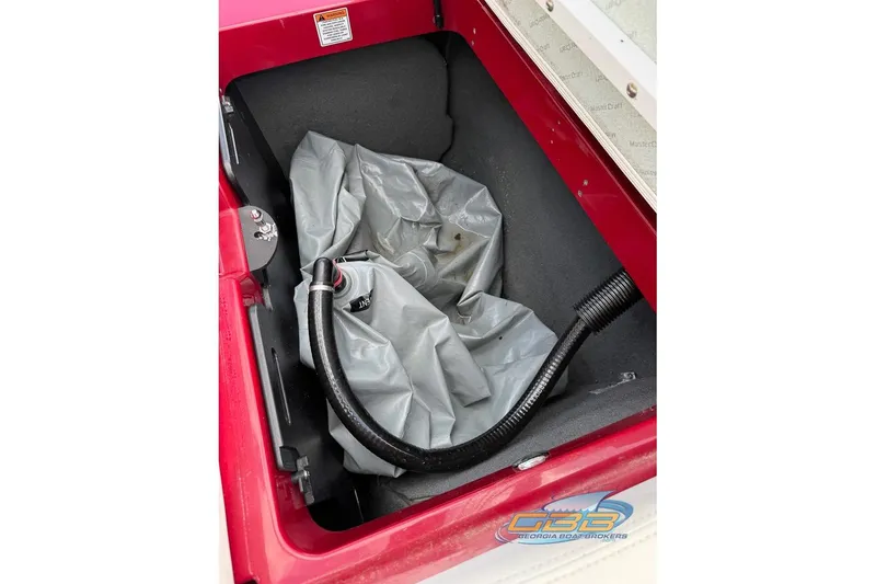 Slide: The Image of Storage compartment of a 2018 MasterCraft XT25 boat with hose and cover. - 31
