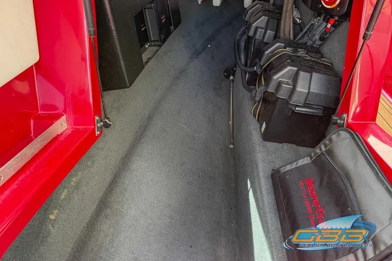 Slide: The Image of Interior view of a 2018 MasterCraft XT25 boat, showcasing storage and engine components. - 32