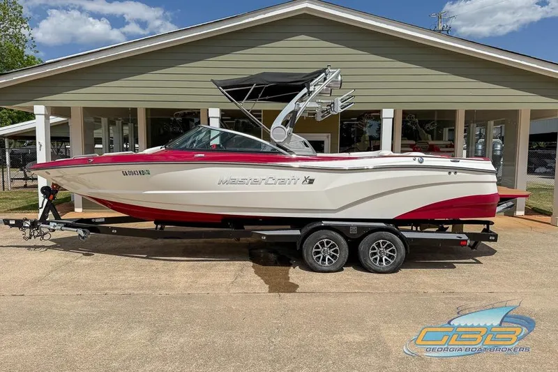 Slide: The Image of 2018 MasterCraft XT25 boat cockpit with red and wood accents, featuring a modern steering wheel. - 4