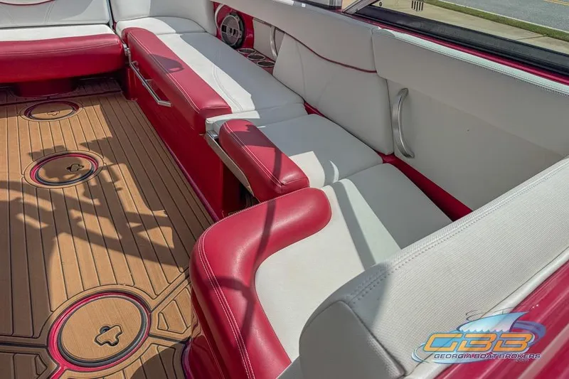 Slide: The Image of Luxurious 2018 MasterCraft XT25 boat interior with red and white seating, teak flooring. - 8