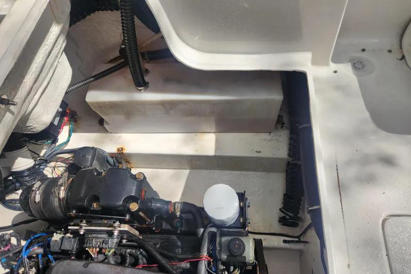 Slide: The Image of Engine compartment of a 2006 Crownline 236 SC boat, showing mechanical components and wiring. - 11