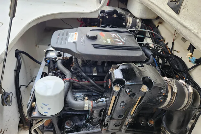 Slide: The Image of Engine compartment of a 2006 Crownline 236 SC boat, featuring a MerCruiser engine. - 14