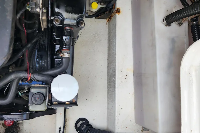 Slide: The Image of Engine compartment of a 2006 Crownline 236 SC boat, showing hoses and components. - 15