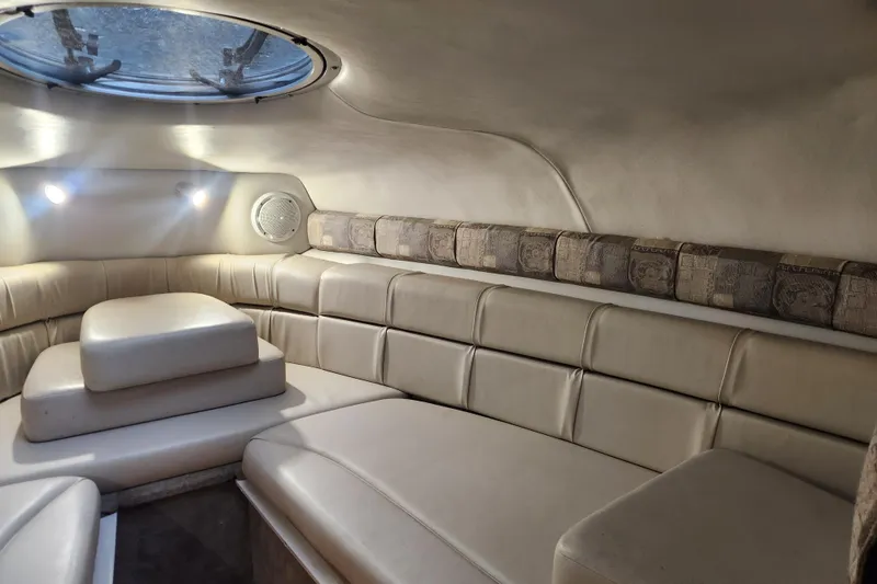 Slide: The Image of Interior cabin of 2006 Crownline 236 SC boat with beige seating and overhead lighting. - 4
