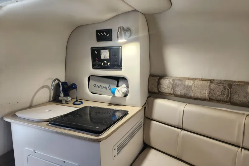 Slide: The Image of 2006 Crownline 236 SC cabin interior with kitchenette and seating area. - 6