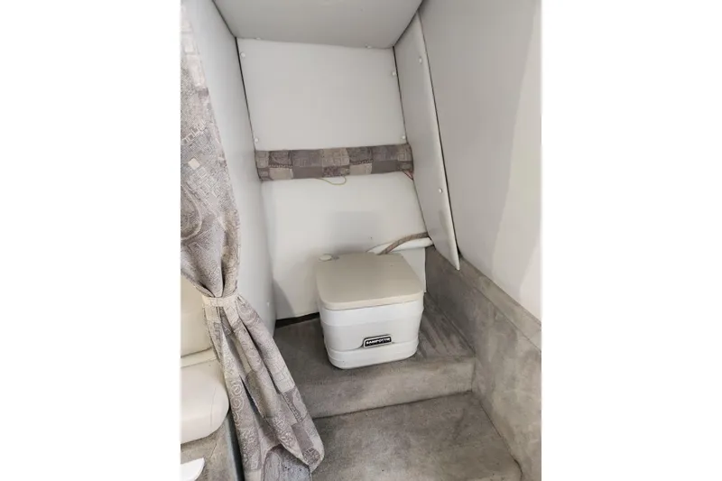 Slide: The Image of Interior of 2006 Crownline 236 SC boat with portable toilet and curtain. - 8