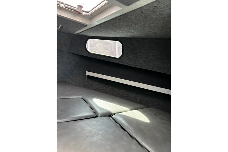 Slide: The Image of Interior cabin of 1998 Maxweld Cuddy Hardtop boat with window and cushioned seating. - 10