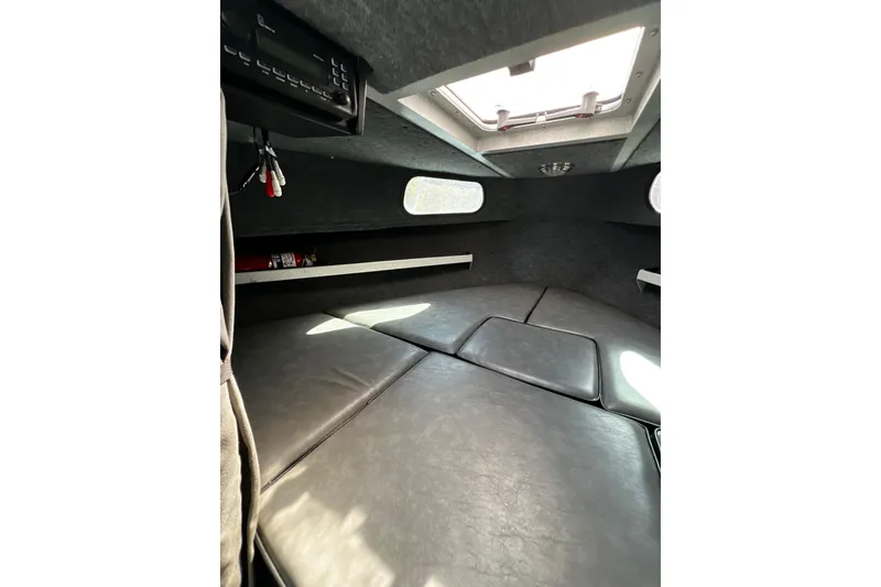 Slide: The Image of Interior cabin of 1998 Maxweld Cuddy Hardtop boat with cushioned seating and overhead hatch. - 11