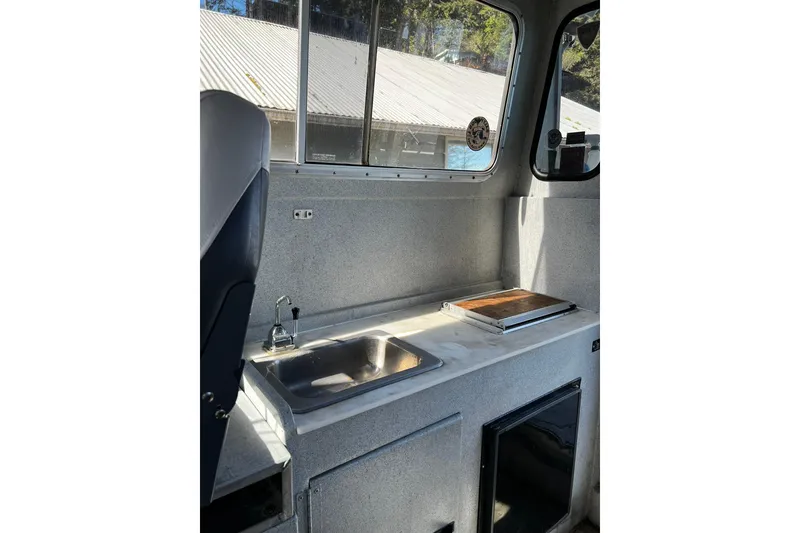 Slide: The Image of Interior of 1998 Maxweld Cuddy Hardtop boat with sink and countertop. - 12