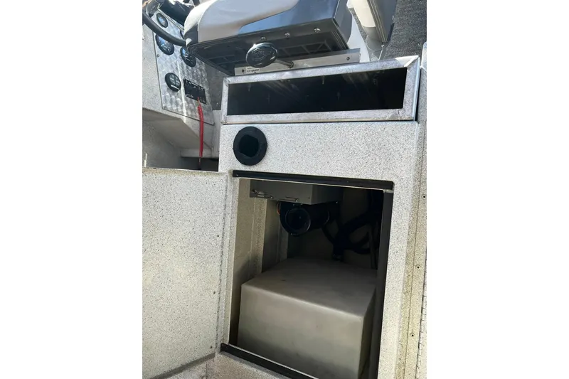 Slide: The Image of 1998 Maxweld Cuddy Hardtop boat interior with storage compartment and control panel. - 16