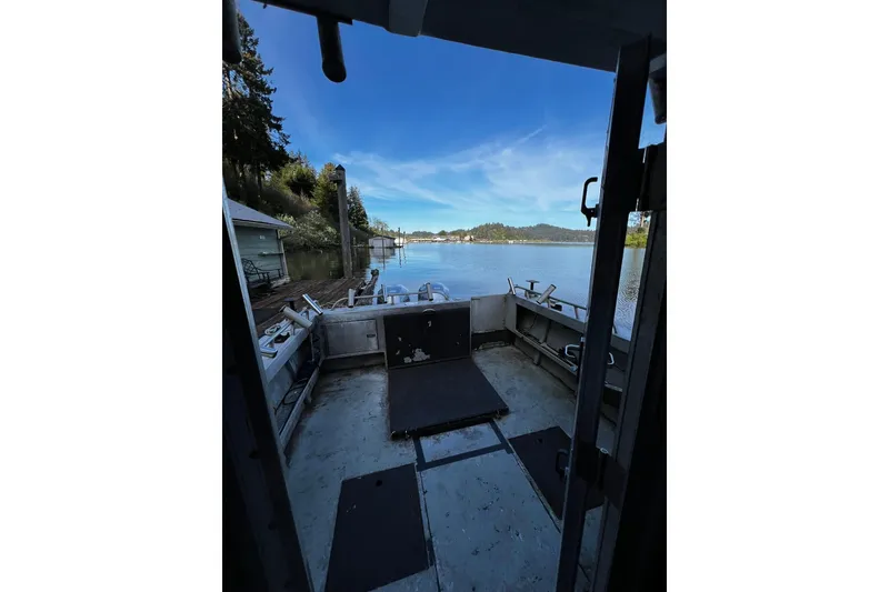 Slide: The Image of 1998 Maxweld Cuddy Hardtop boat interior with scenic waterfront view. - 17
