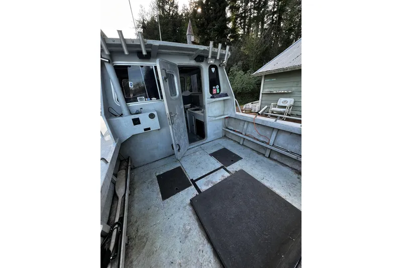 Slide: The Image of 1998 Maxweld Cuddy Hardtop boat interior with open deck and visible seating area. - 18