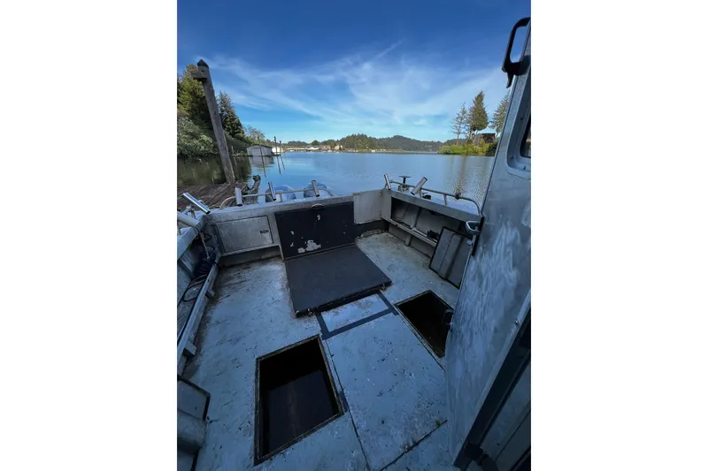 Slide: The Image of 1998 Maxweld Cuddy Hardtop boat interior with open deck, overlooking serene lake and trees. - 19
