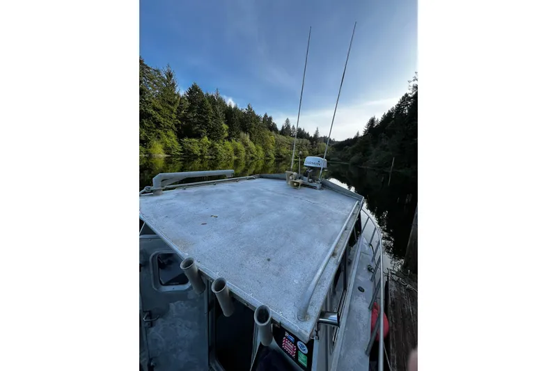 Slide: The Image of 1998 Maxweld Cuddy Hardtop boat on a serene forested river. - 24