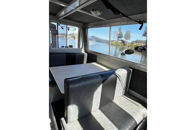 Slide: The Image of Interior of 1998 Maxweld Cuddy Hardtop boat with lake view through windows. - 3