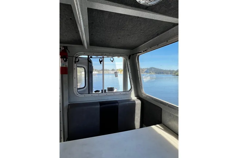 Slide: The Image of Interior view of 1998 Maxweld Cuddy Hardtop boat with scenic water view. - 4