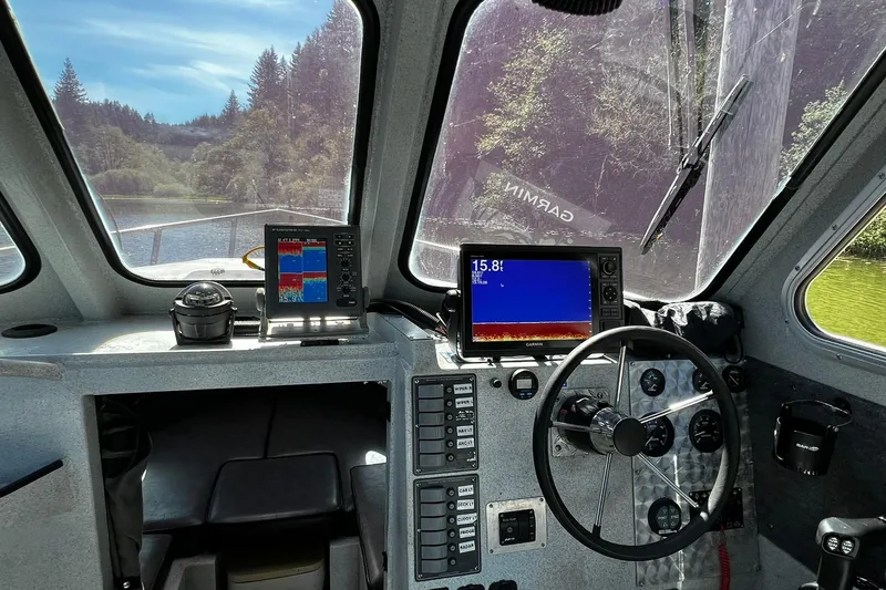 Slide: The Image of Interior of 1998 Maxweld Cuddy Hardtop boat with navigation equipment and steering wheel. - 5