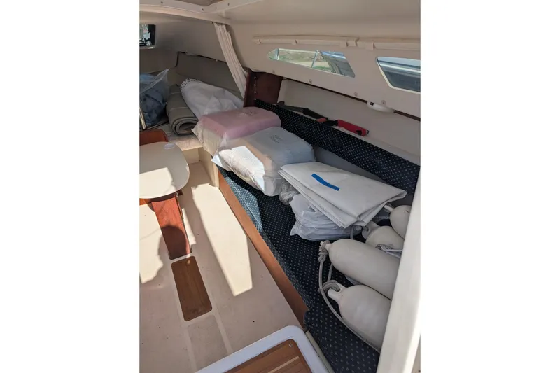 Slide: The Image of Interior of 2007 Catalina 22 Mark II sailboat with cushions and storage items. - 14