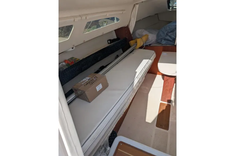 Slide: The Image of Interior of 2007 Catalina 22 Mark II sailboat with storage and seating area. - 15