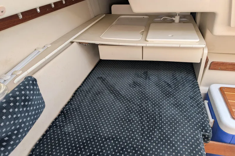 Slide: The Image of Interior of 2007 Catalina 22 Mark II sailboat with compact kitchenette and cushioned seating. - 16