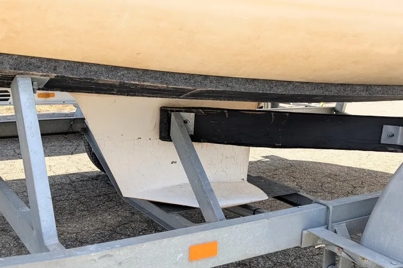 Slide: The Image of 2007 Catalina 22 Mark II sailboat keel on trailer, showing wear and cracks. - 2