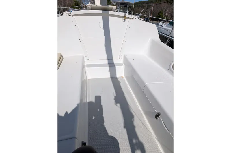 Slide: The Image of 2007 Catalina 22 Mark II sailboat cockpit, featuring clean white seating and deck. - 4
