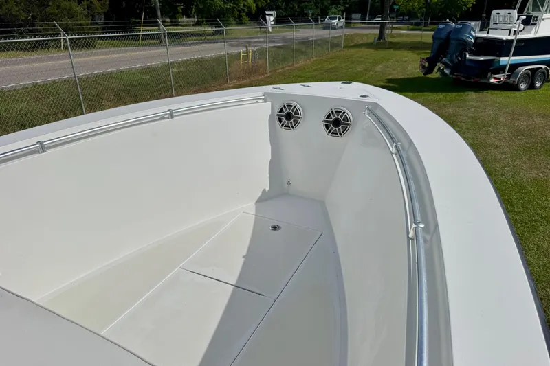 Slide: The Image of 2010 Contender 21 Open boat interior with speakers, parked on grass near a road. - 5