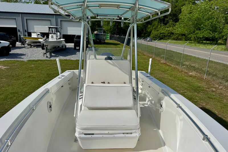 Slide: The Image of 2010 Contender 21 Open boat with seating, parked outdoors near storage units. - 6