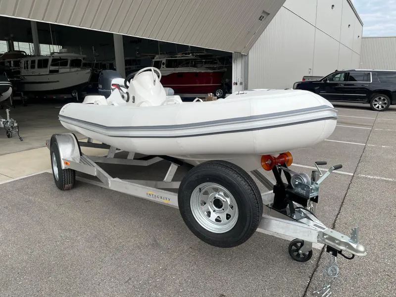 Slide: The Image of Zodiac Yachtline 440 DL NEO 60hp on trailer, 2026 model. - 2