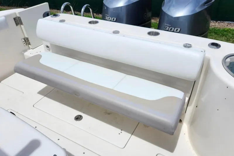 Slide: The Image of 2015 Robalo R300 Center Console boat with foldable rear seating and dual Yamaha 300 engines. - 13