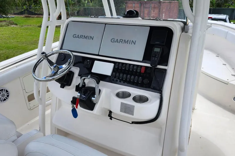 Slide: The Image of 2015 Robalo R300 Center Console helm with Garmin displays and controls. - 19