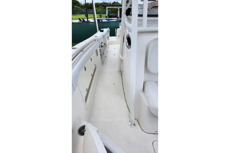 Slide: The Image of 2015 Robalo R300 Center Console boat interior, featuring white seating and deck. - 28
