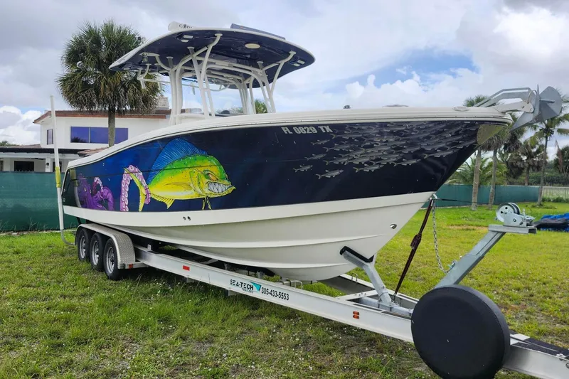 Slide: The Image of 2015 Robalo R300 Center Console boat with vibrant marine artwork on trailer. - 3