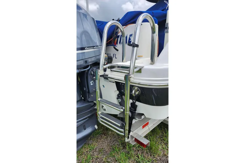 Slide: The Image of 2015 Robalo R300 Center Console boat with stainless steel ladder and outboard motor. - 39