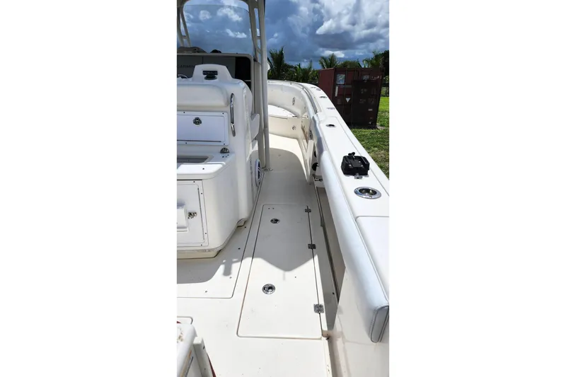 Slide: The Image of 2015 Robalo R300 Center Console boat deck with seating and storage compartments. - 5