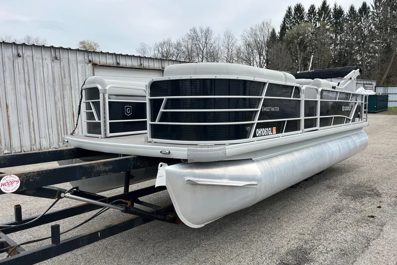 Slide: The Image of 2023 Godfrey Sweetwater 2286 pontoon boat on trailer, parked outdoors. - 3