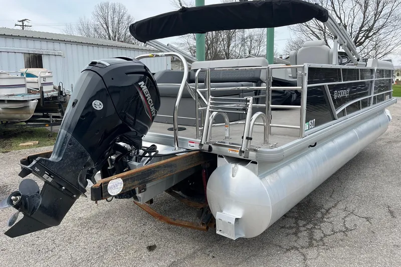Slide: The Image of 2023 Godfrey Sweetwater 2286 pontoon boat with Mercury outboard motor, parked outdoors. - 4