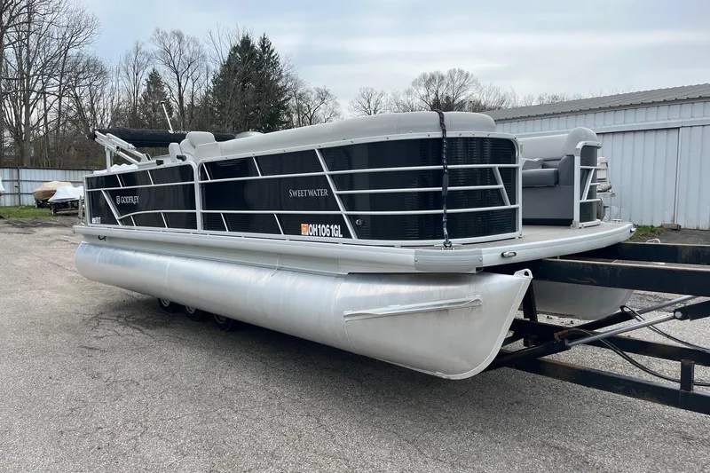 Slide: The Image of 2023 Godfrey Sweetwater 2286 pontoon boat on trailer, parked outdoors. - 6