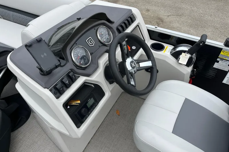 Slide: The Image of 2023 Godfrey Sweetwater 2286 boat dashboard with steering wheel and control panel. - 7