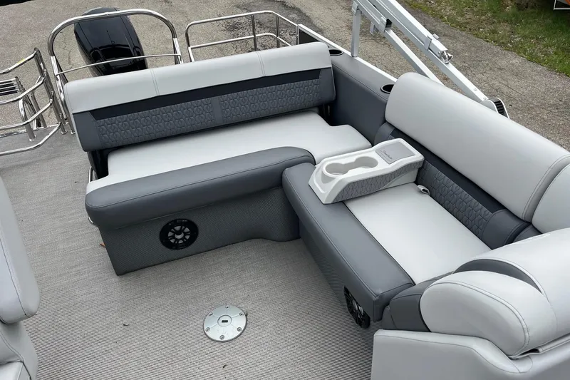 Slide: The Image of 2023 Godfrey Sweetwater 2286 boat interior with gray seating and cup holders. - 9